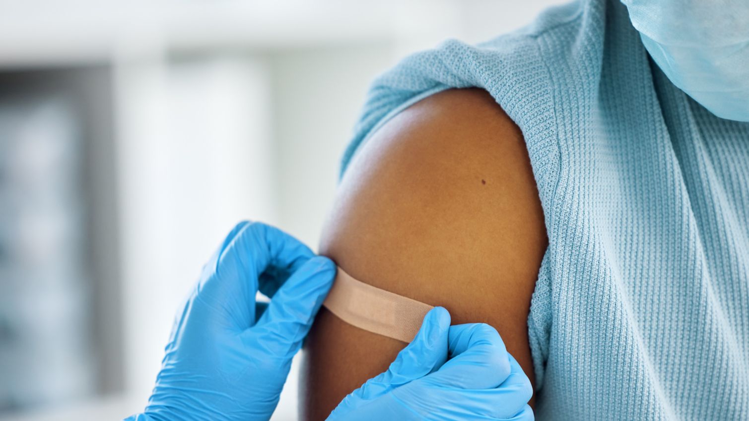 Medicaid doctor applies a bandage after vaccination